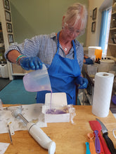 A student pouring soap into a mould