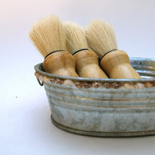 old fashioned shaving brushes in tin